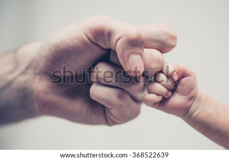 Fist of Dad and Newborn Baby Royalty-Free Stock Photo #368522639