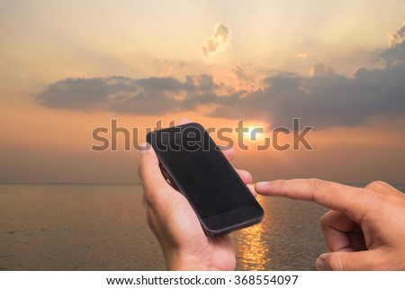Man using his Mobile Phone outdoor, close up . tablet. 