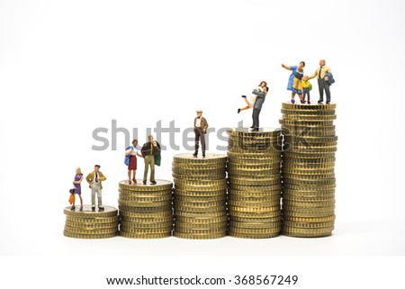 Faily budget concept. Miniature family on coins pile. Macro photo