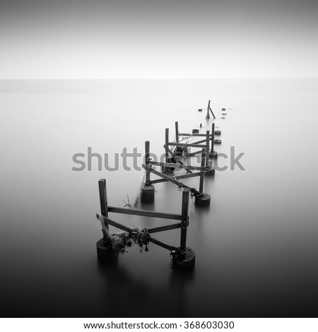 Black and white of old jetty at tropical beach Royalty-Free Stock Photo #368603030