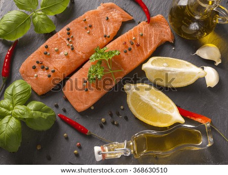 Delicious portion of fresh salmon fillet with aromatic herbs, spices 