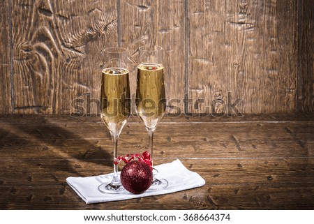 Two beautiful glasses of champagne are standing on a white napkin on an old table