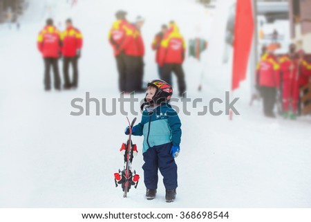 toddler boy skiing in the mountains, winter time