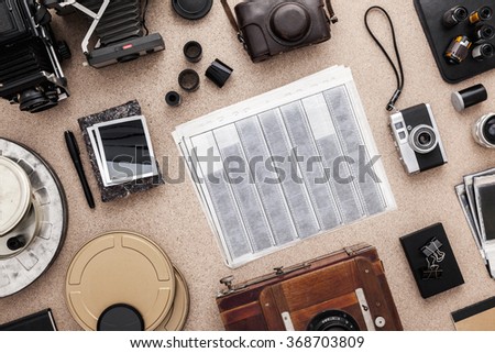 Photographer's desk, old cameras, traditional photography. Negatives.
