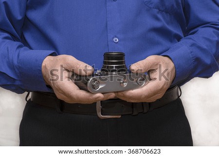 the camera in the hands of men