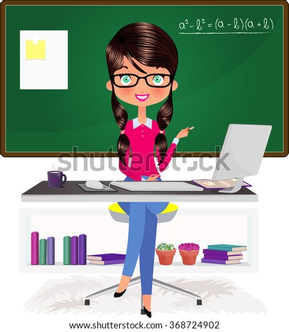 Beautiful brunette teacher, instructor at her desk with a computer by a chalkboard 