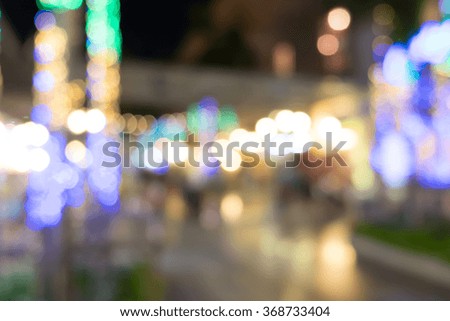 blurred background night market on street decorated with festive lights.