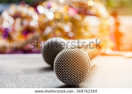 close up microphone on table, over blurred bokeh background.