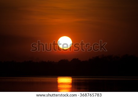 Full sunset reflection on water 