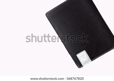 Black leather book on white background.