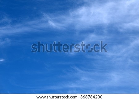 Beautiful, fluffy, white clouds and blue sky. Image has a beautiful grain texture seen at 100 percent of its size