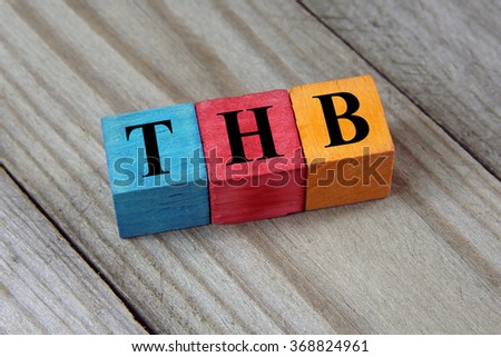 THB (Thai Baht) sign on colorful wooden cubes