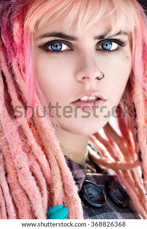 Dreadlocks. Fashion hairstyle  pink with dreads - beauty woman face