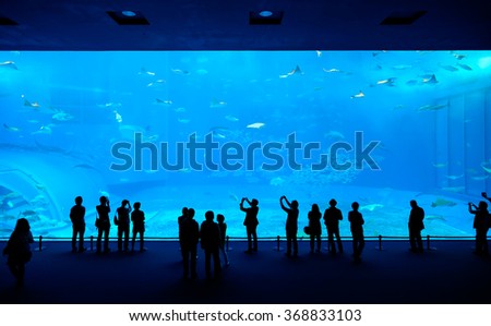 Silhouettes of people and giant whale shark of fantasy underwater in Oceanarium