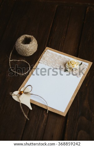 The basis for the writing on the brown wooden table in retro style hand made paper rose