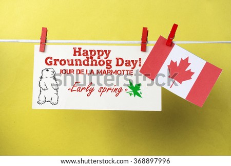White envelope, cute face groundhog and text Happy Groundhog Day - Early spring. Canada flag hanging on colorful pegs  clothespin. Jour de la Marmotte - Groundhog Day Canadian on French. Toned image