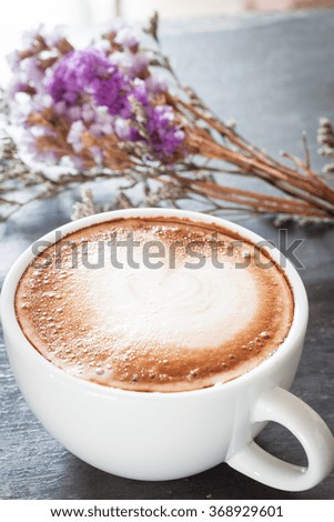 Coffee cup with beautiful violet flower, stock photo