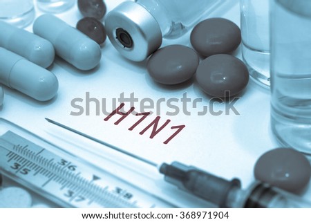 h1n1 - diagnosis written on a white piece of paper. Syringe and vaccine with drugs. Swine flu. Royalty-Free Stock Photo #368971904