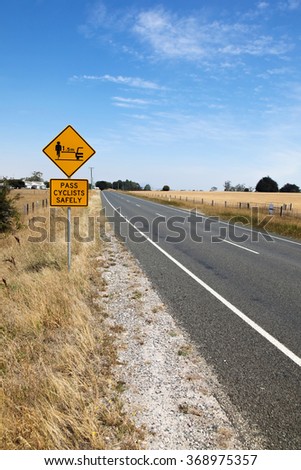 A cycling safety sign on the side of the road in Tasmania - Australia. Cycling in Tasmania is a popular pursuit and road safety campaigns are becoming more widespread.