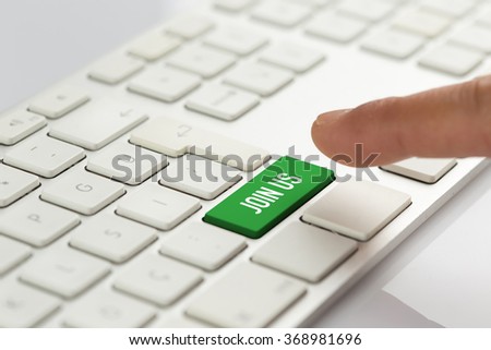 Computer Keyboard Concept: Hand pushing green JOIN US keyboard button