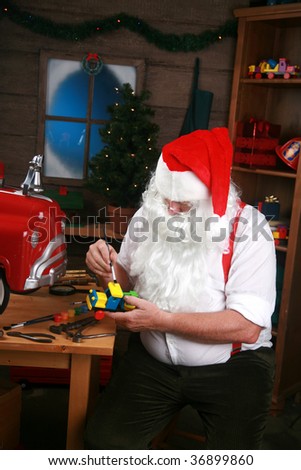 Santa in his workshop making new toys for Christmas Presents for children around the world