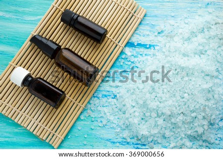 bottles essential oil and sea salt on a blue wooden table, Spa 