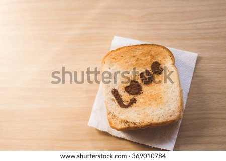Love message on Bread sliced on wooden background.