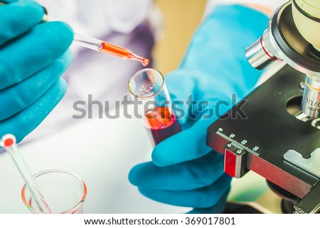 Hands of clinician holding tools during scientific experiment in laboratory,MERS