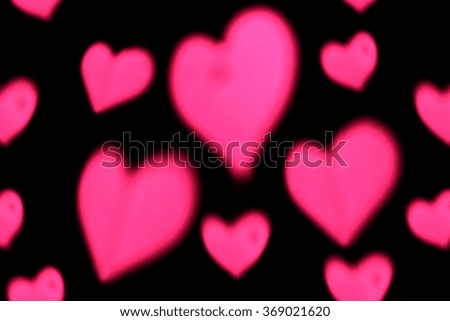 Abstract hearts bokeh on black background 