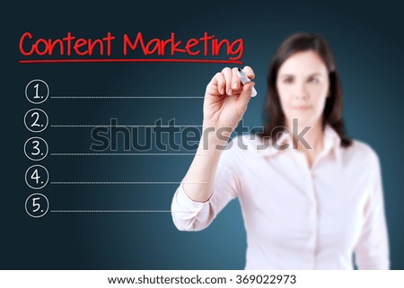 Business woman writing blank Content Marketing list. Blue background. 