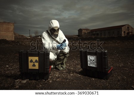 Earth after nuclear war - soldier checking samples of soil Royalty-Free Stock Photo #369030671