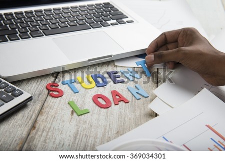 Hand arrange wood letters as student Loan word  Royalty-Free Stock Photo #369034301