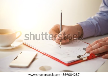 The male hand drawing a graph of growth against the background of the table
