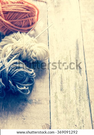 Yarn on a wooden background/toned photo