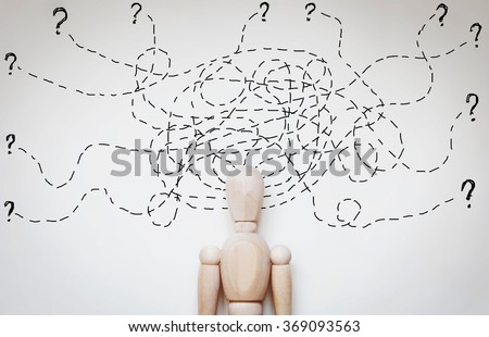 Man under stress because of too much problems. Abstract image with a wooden puppet Royalty-Free Stock Photo #369093563
