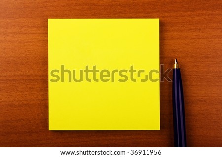 sticker with pen on wooden background