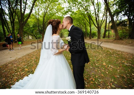 wedding couple. Beautiful bride and groom. Just married. Close up. Happy bride and groom on their wedding hugging. Groom and Bride in a park. wedding dress. Bridal wedding, autumn