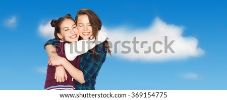 happy smiling pretty teenage girls hugging