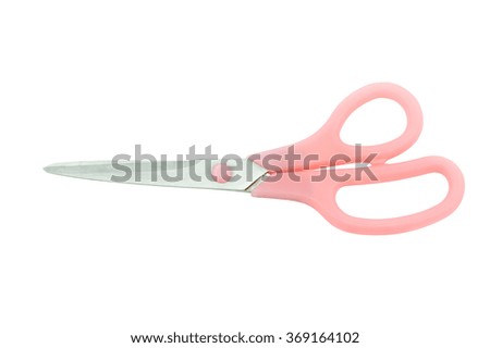 Old scissors cut paper pink on white background.