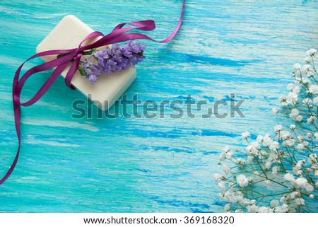 mockup natural organic soap with flowers on a blue wooden table 