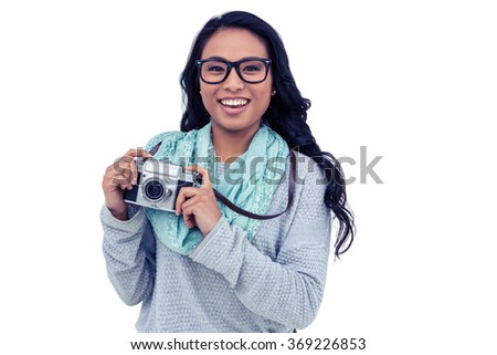 Asian woman holding digital camera on white screen