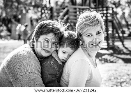 Grandmother,  mother and grandson in autumn in a park. Black and white photography