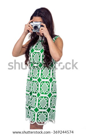 Asian woman taking picture with digital camera on white screen