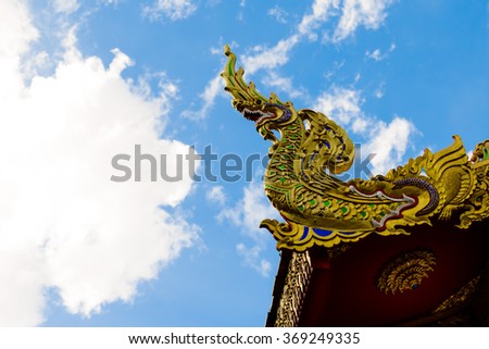 serpent king or king of naga statue in thai temple on blue sky background