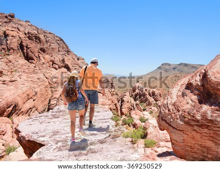 Father and daughter hiking in Red Rock Canyon, Nevada, USA.  Royalty-Free Stock Photo #369250529