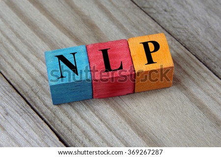 NLP (Neuro Linguistic Programming) sign on colorful wooden cubes
