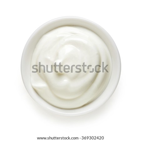 Bowl of cream on white background, top view Royalty-Free Stock Photo #369302420