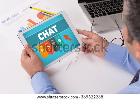 Man working on tablet with CHAT on a screen