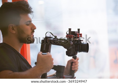 videographer with gimball video slr Royalty-Free Stock Photo #369324947