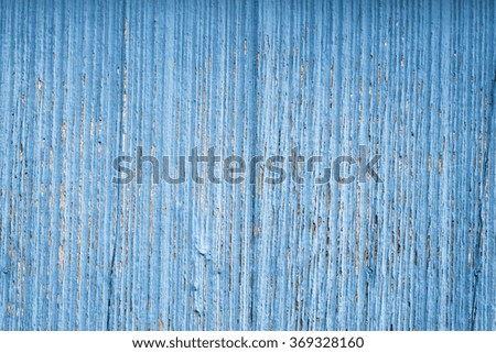wood panel texture with a worn out, faded blue paint as background